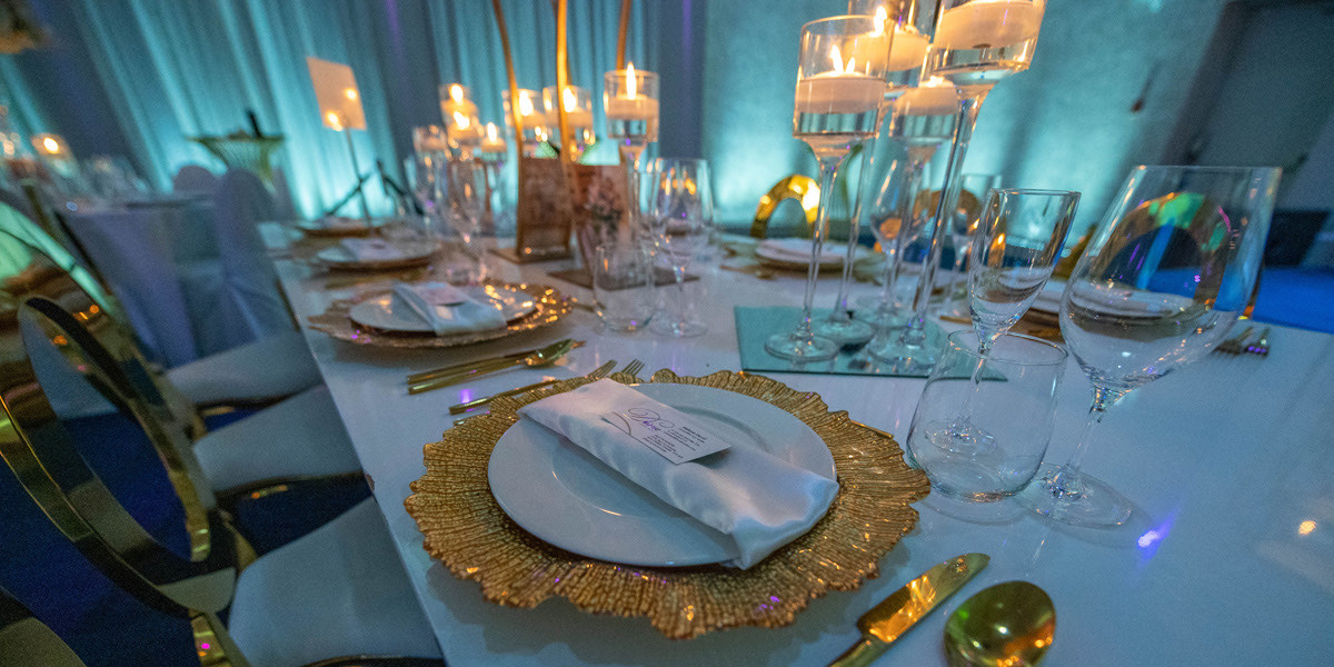 Wedding head table with floral runner and gold accents